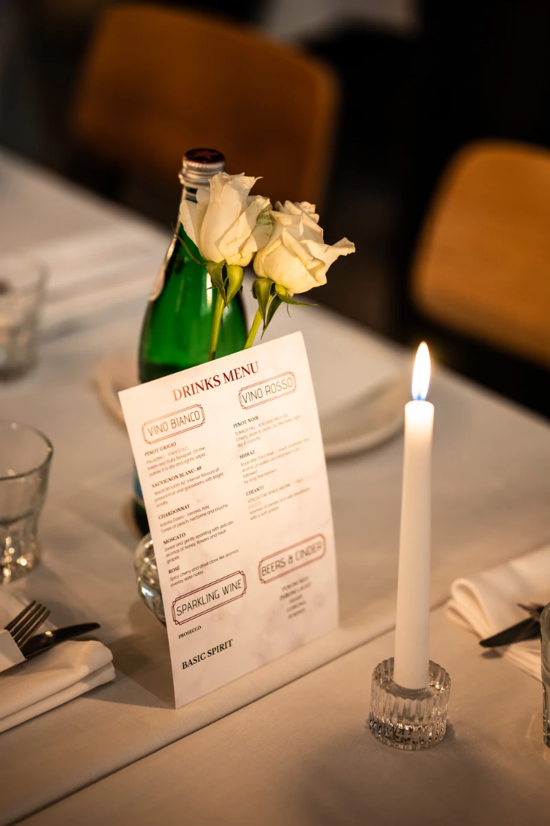 dinner date table setting with candle and white roses